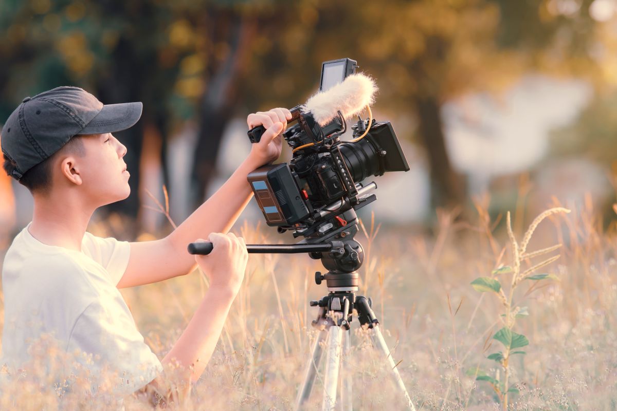 Camera man adjusting camera in the outdoors